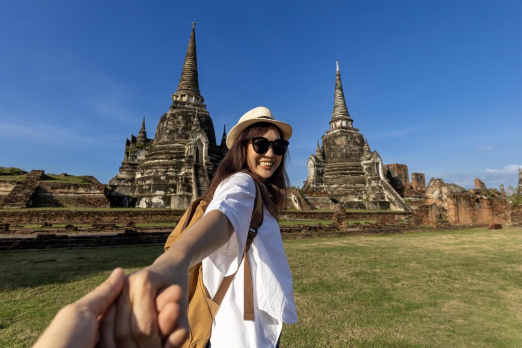 Couple of Asian tourist come to visit at Wat Phra Si Sanphet temple, Ayutthaya Thailand, for travel, vacation, holiday, honeymoon and tourism concept Stock Free