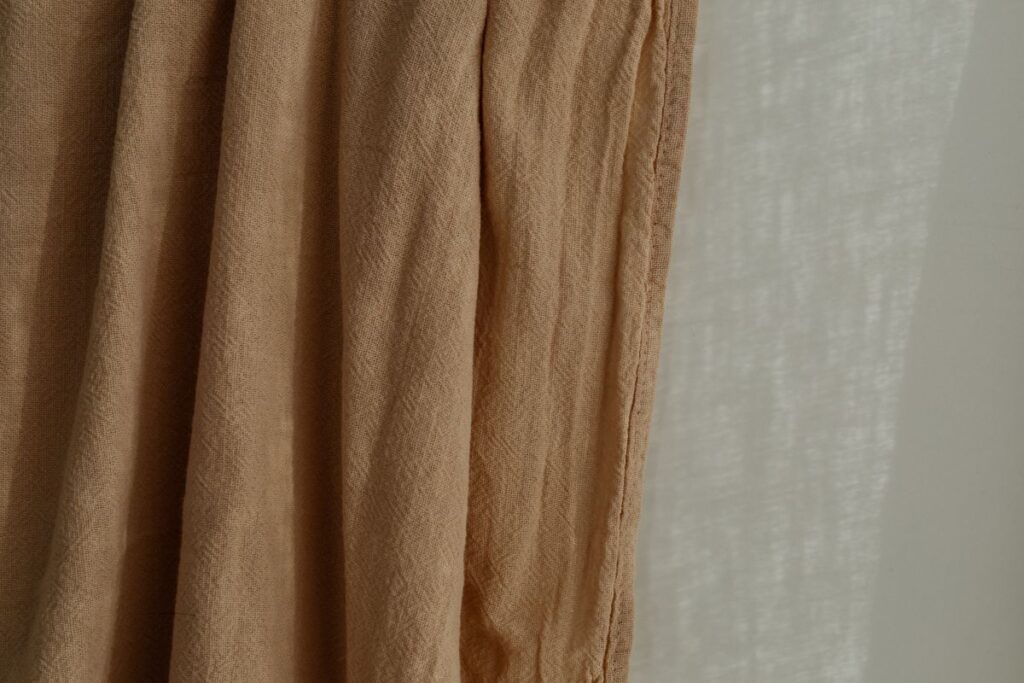 Wrinkled curtain in beige or brown color Stock Free