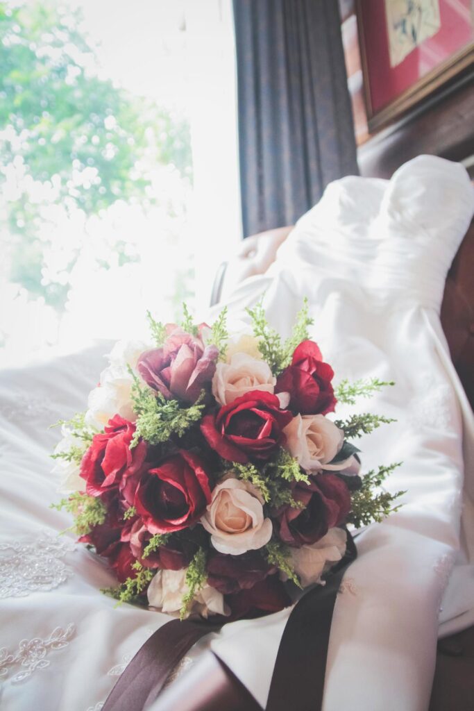 Beautiful rose Flowers bouquet on wedding dress bride on vintage chair . Valentine day Stock Free