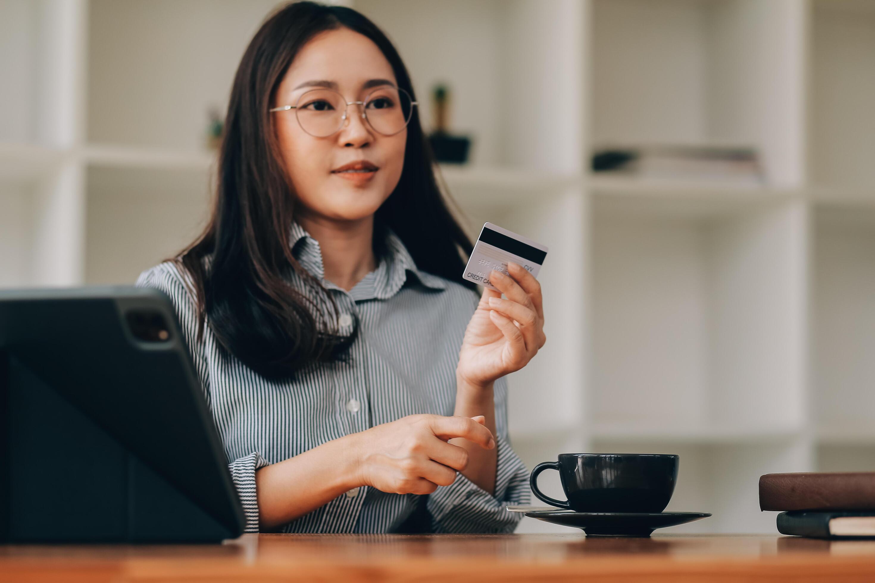 Happy asian woman using smartphone shopping online with credit card. Lifestyle. Easy pay using smart phone or digital device. Stock Free