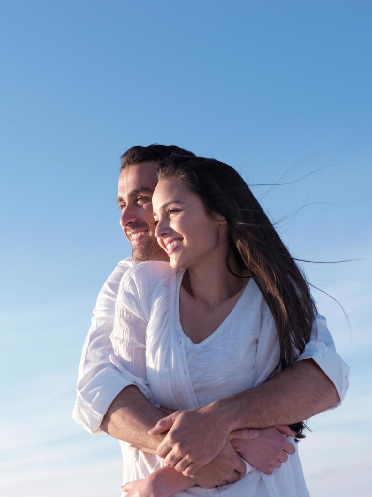 young couple on beach have fun Stock Free