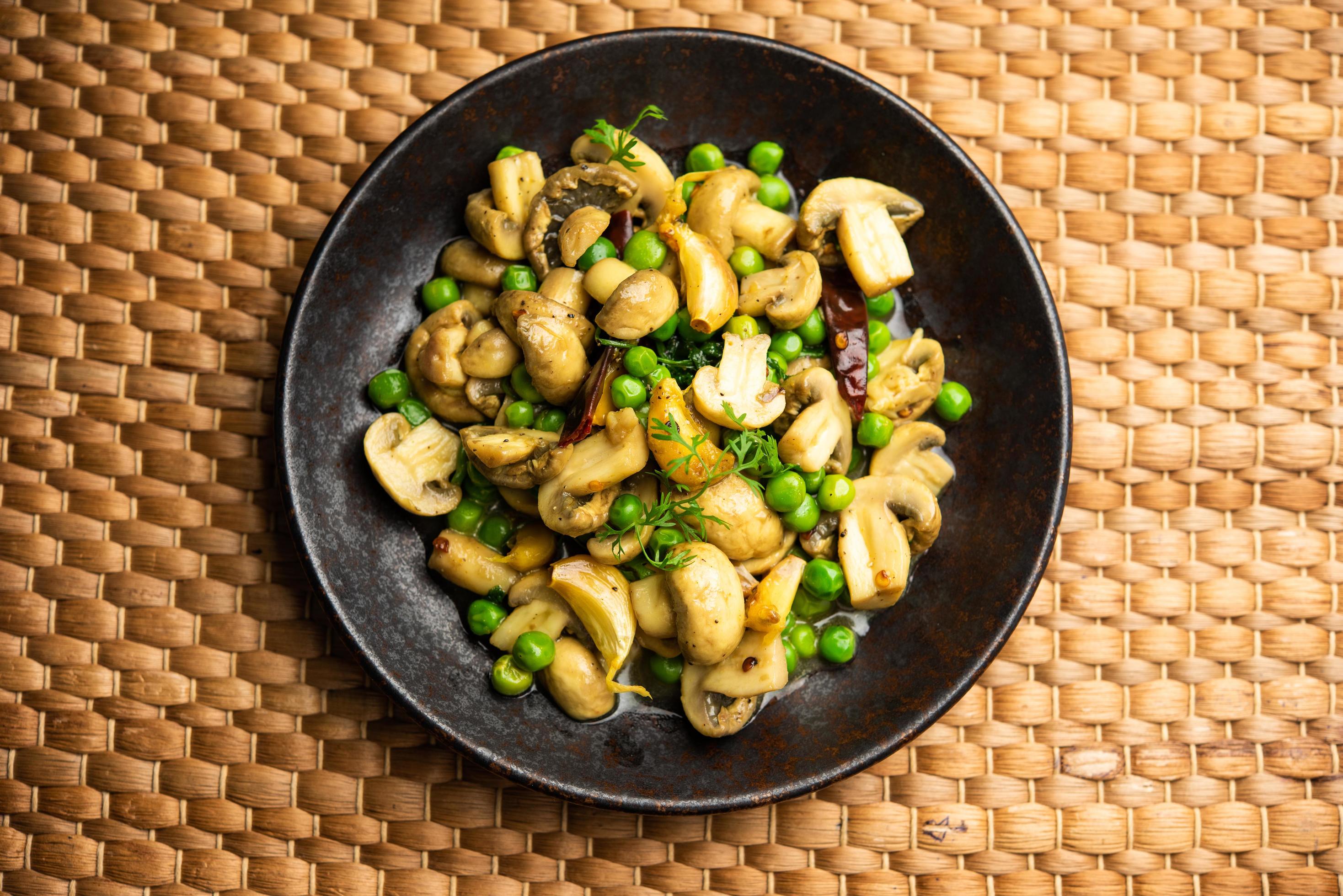 Mushroom and Pea Curry with Roasted Garlic, Indian food served in a bowl Stock Free