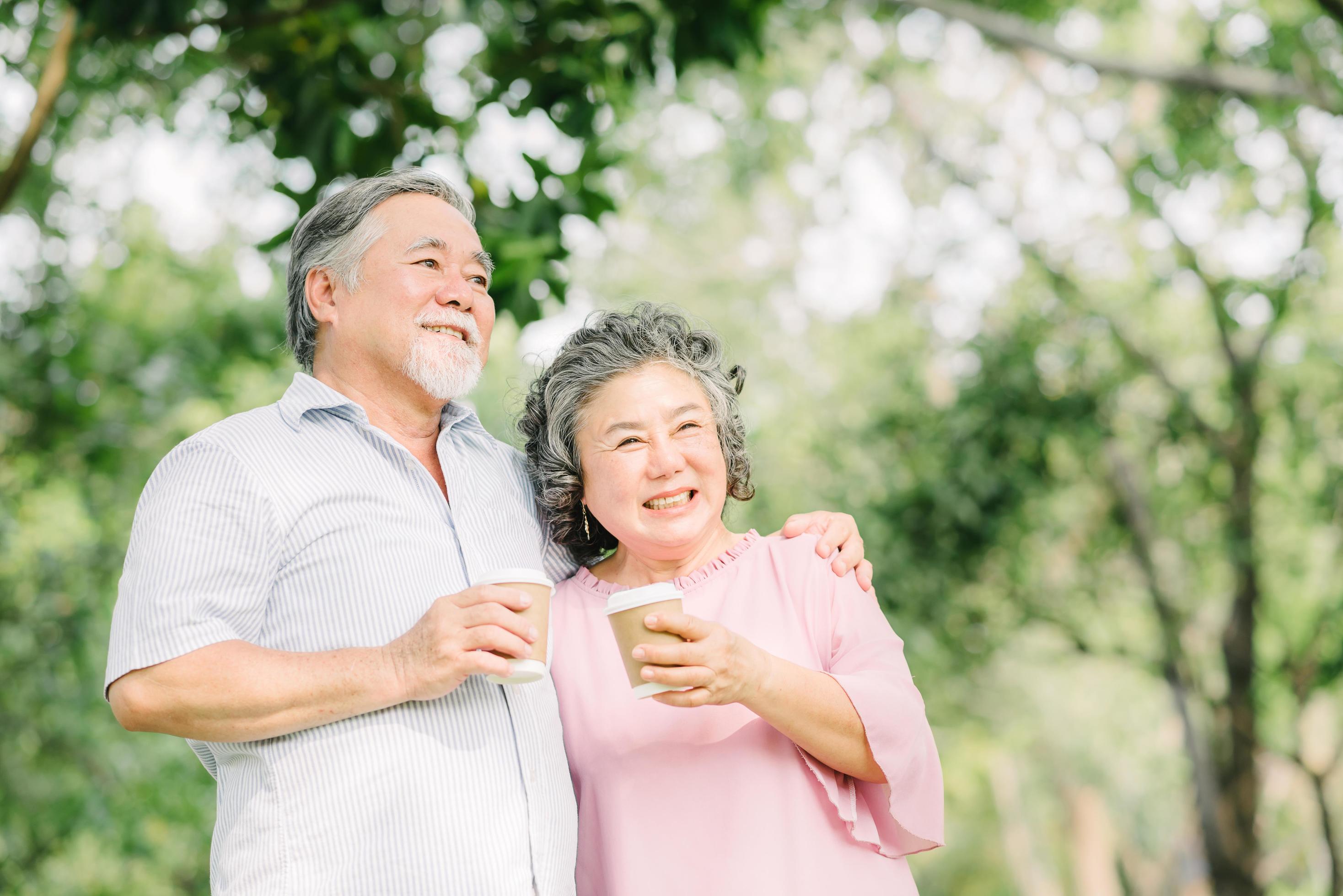 Happy older couple drink coffee together Stock Free