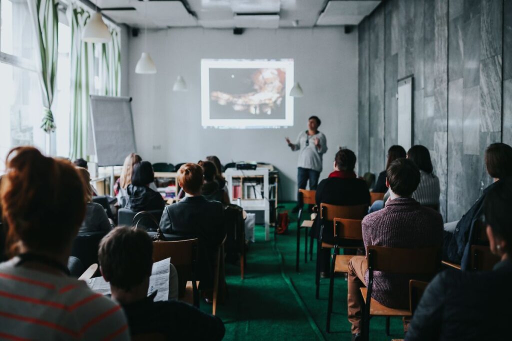 People watching a presentation in a room Stock Free