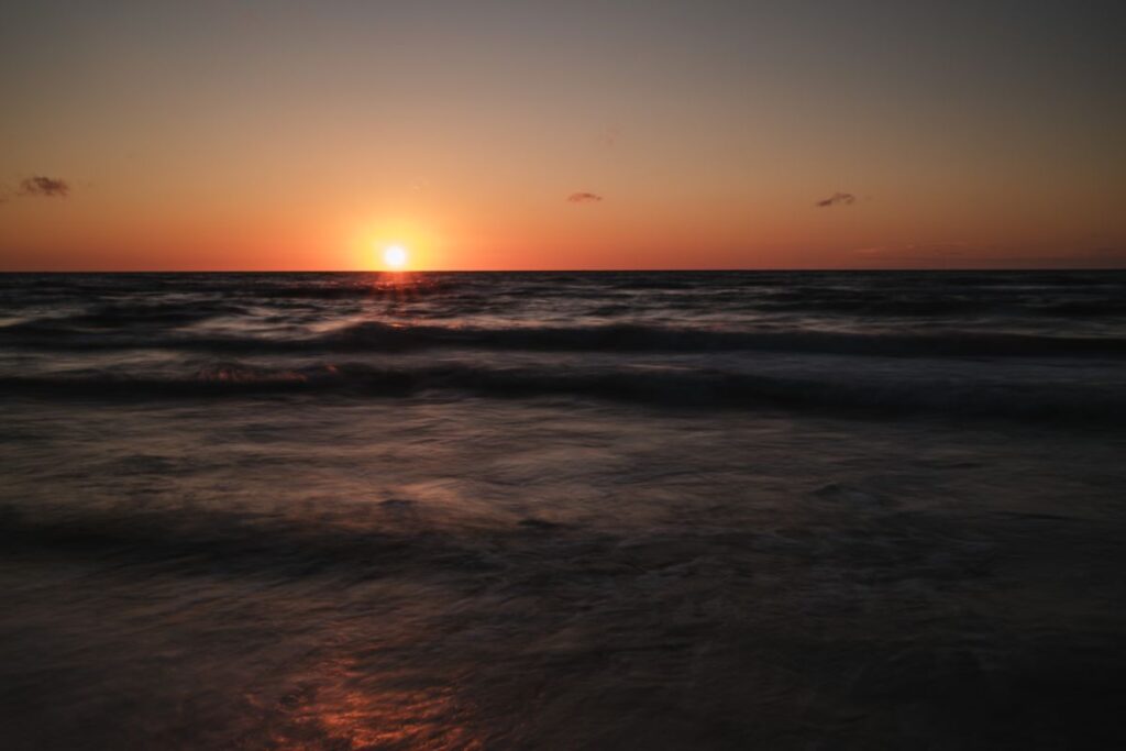 Sunset Reflections: A Tranquil Coastal Journey Stock Free