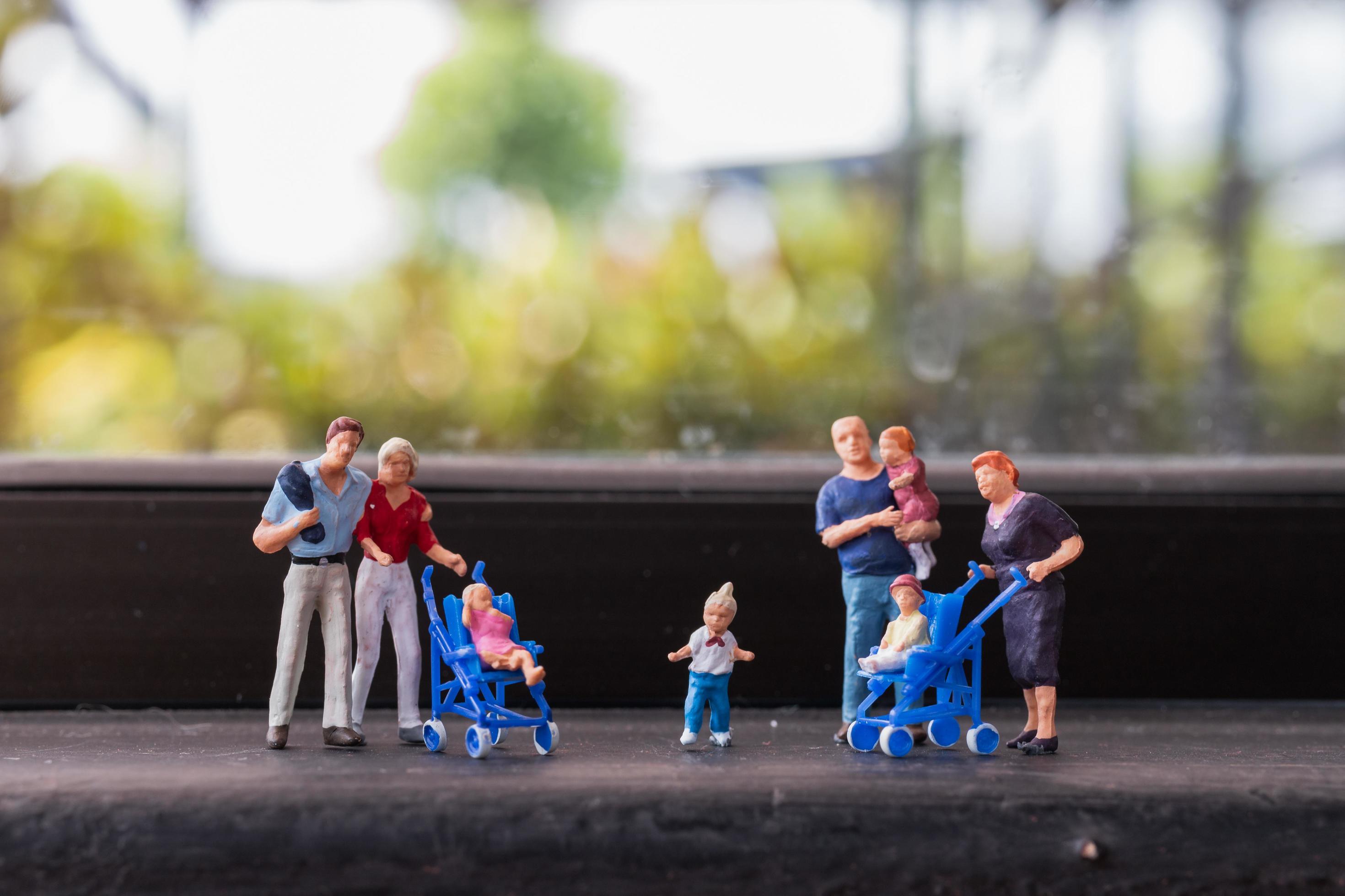 Miniature parents with children walking outdoors, happy family concept Stock Free