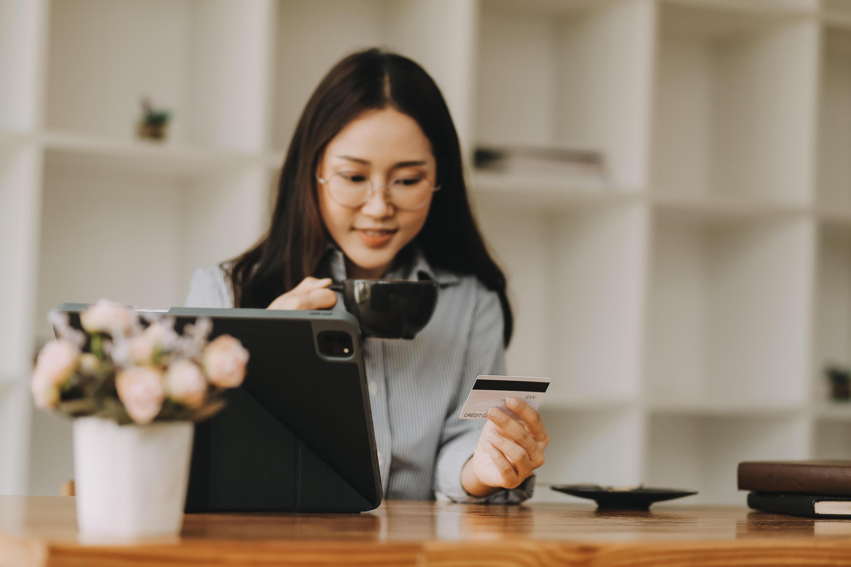 Happy asian woman using smartphone shopping online with credit card. Lifestyle. Easy pay using smart phone or digital device. Stock Free