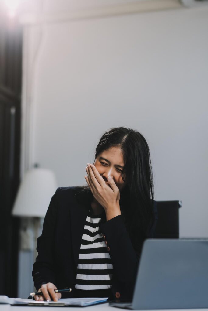 Office asian business woman stretching body for relaxing while working with laptop computer at her desk, office lifestyle, business situation Stock Free