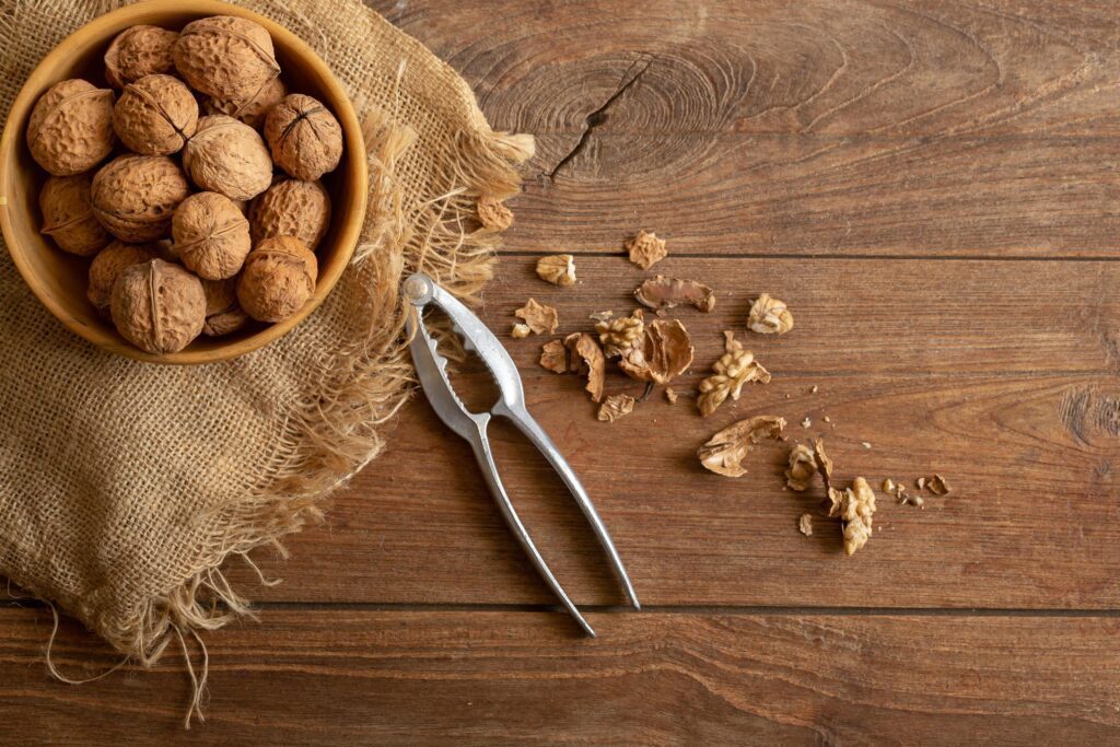 Walnuts kernels in wooden bowl, Walnut healthy food Top view Stock Free