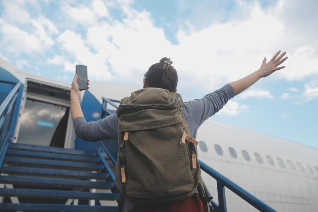 Happy attractive asian woman traveler with backpack at the modern airport terminal, copy space, Tourist journey trip concept Stock Free