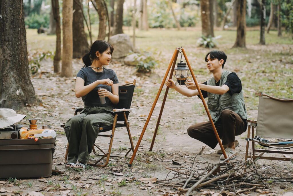 Asian couple sweet in tent inside on they camping trip, traveller relax and sleep togather in out door and camping trip Stock Free