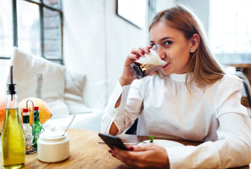 Pretty blonde woman sitting in the cafe Stock Free