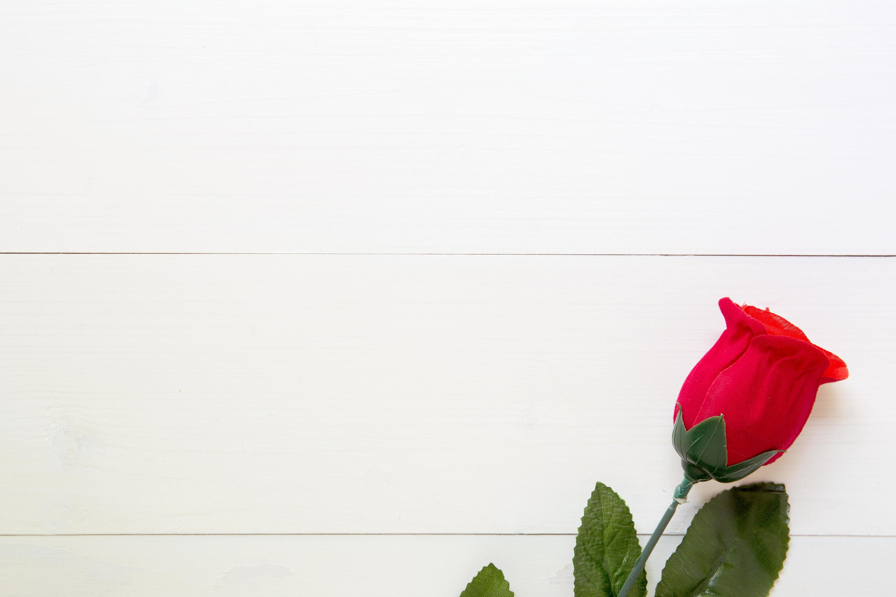 Present gift with red rose flower on wooden table, 14 February of love day with romantic, valentine holiday concept, top view. Stock Free