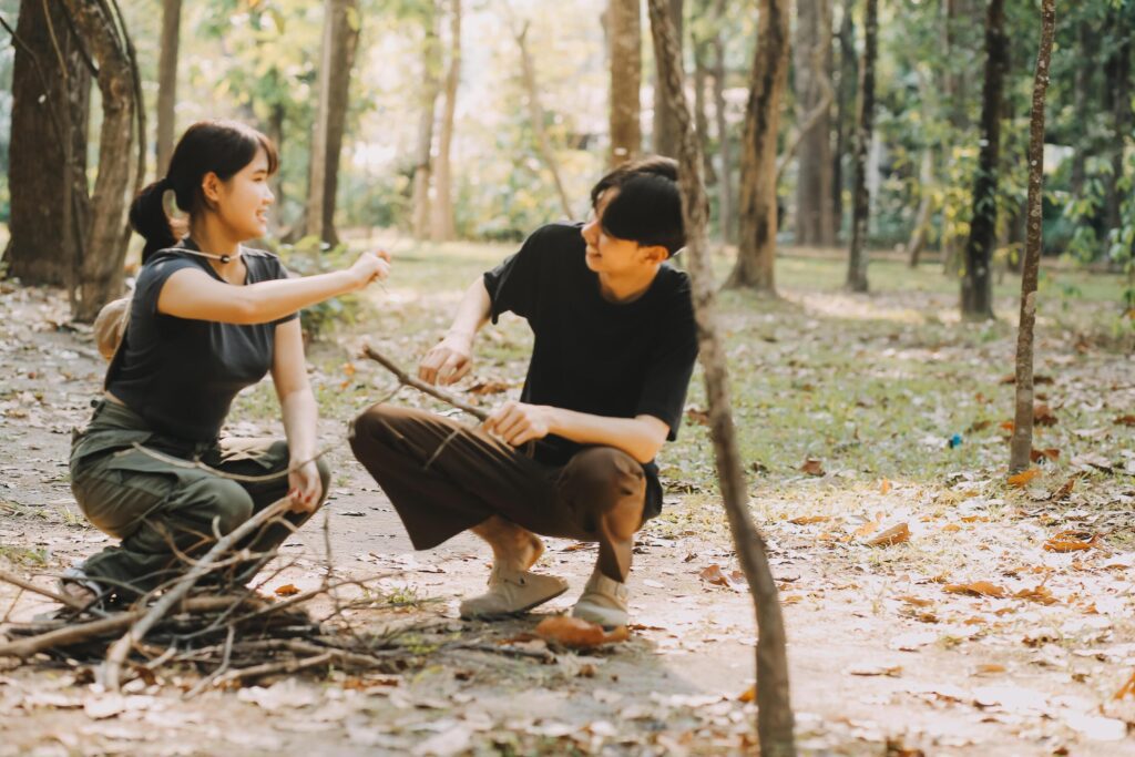 Asian couple sweet in tent inside on they camping trip, traveller relax and sleep togather in out door and camping trip Stock Free