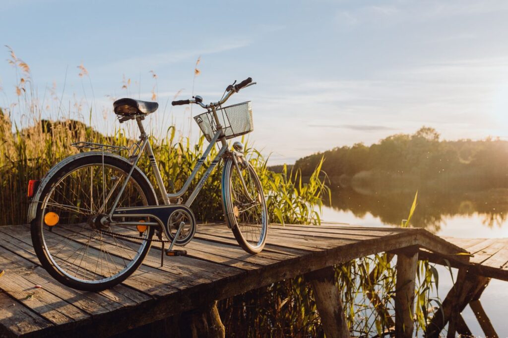 Bicycle with basket on the pier in bright sunset light Stock Free