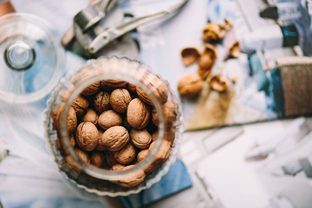 Jar full of walnuts with a fresh healthy shake and musli in a bowl Stock Free