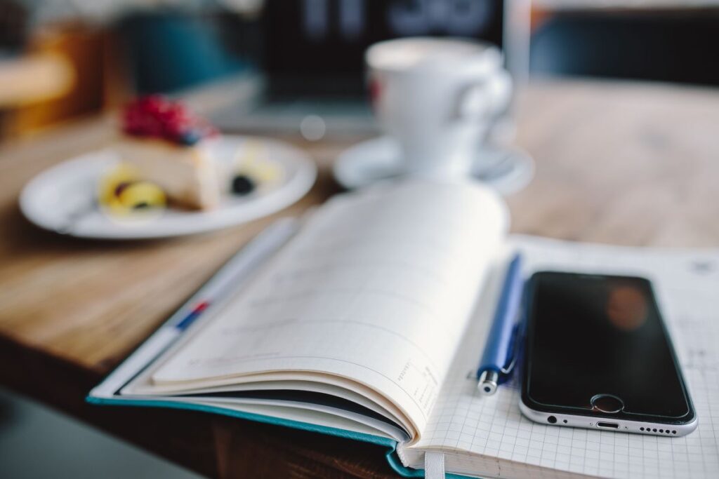 Working in a restaurant: Macbook, Cheese Cake and Cup of Coffee Stock Free