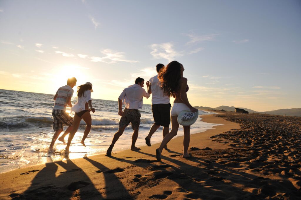 people group running on the beach Stock Free