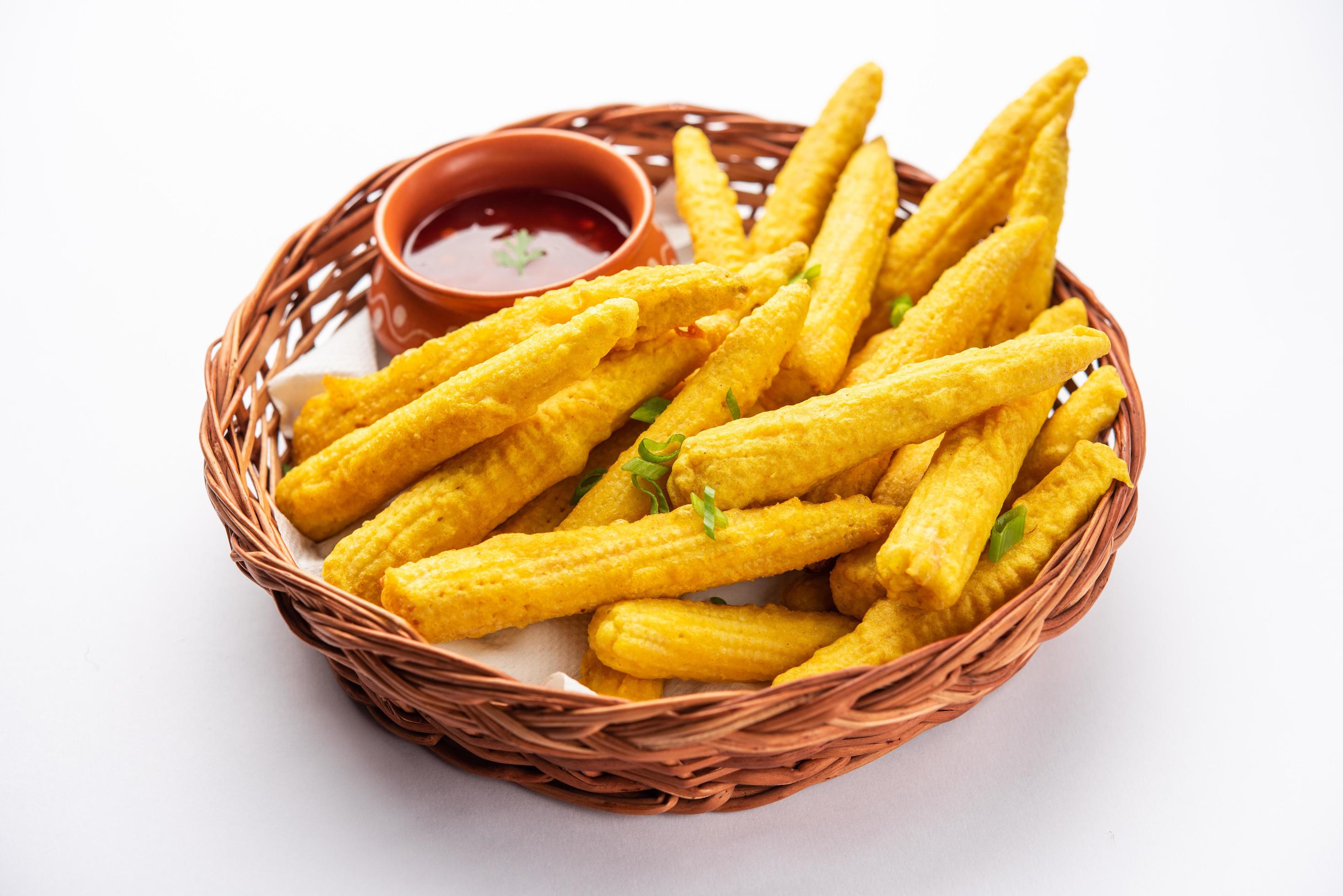 Crispy fried baby corn pakoda, pakora or Baby corn fritters served with ketchup, Indian food Stock Free