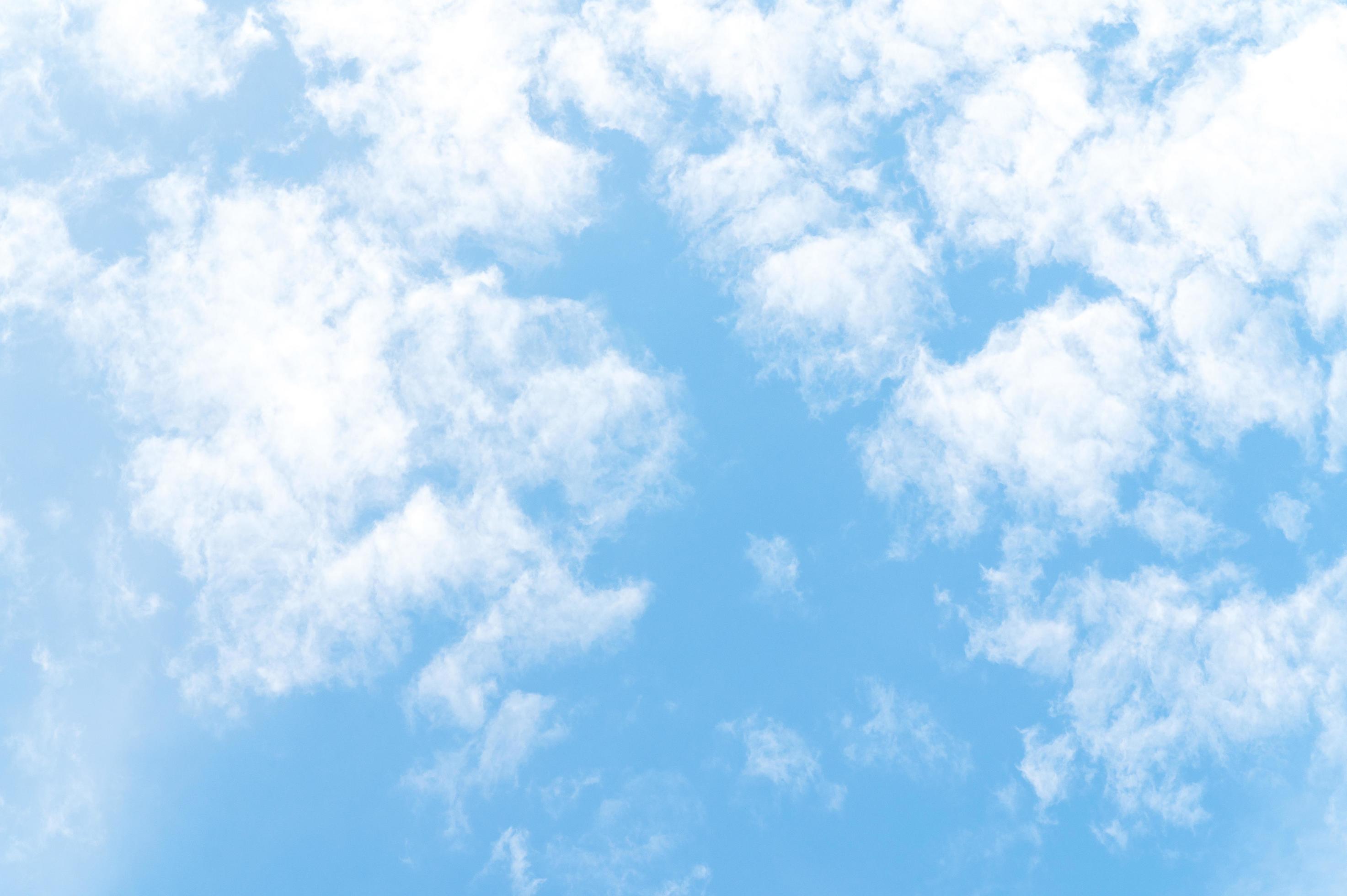 Nature background from white clouds in sunny day. Beautiful white fluffy clouds in blue sky. Stock Free