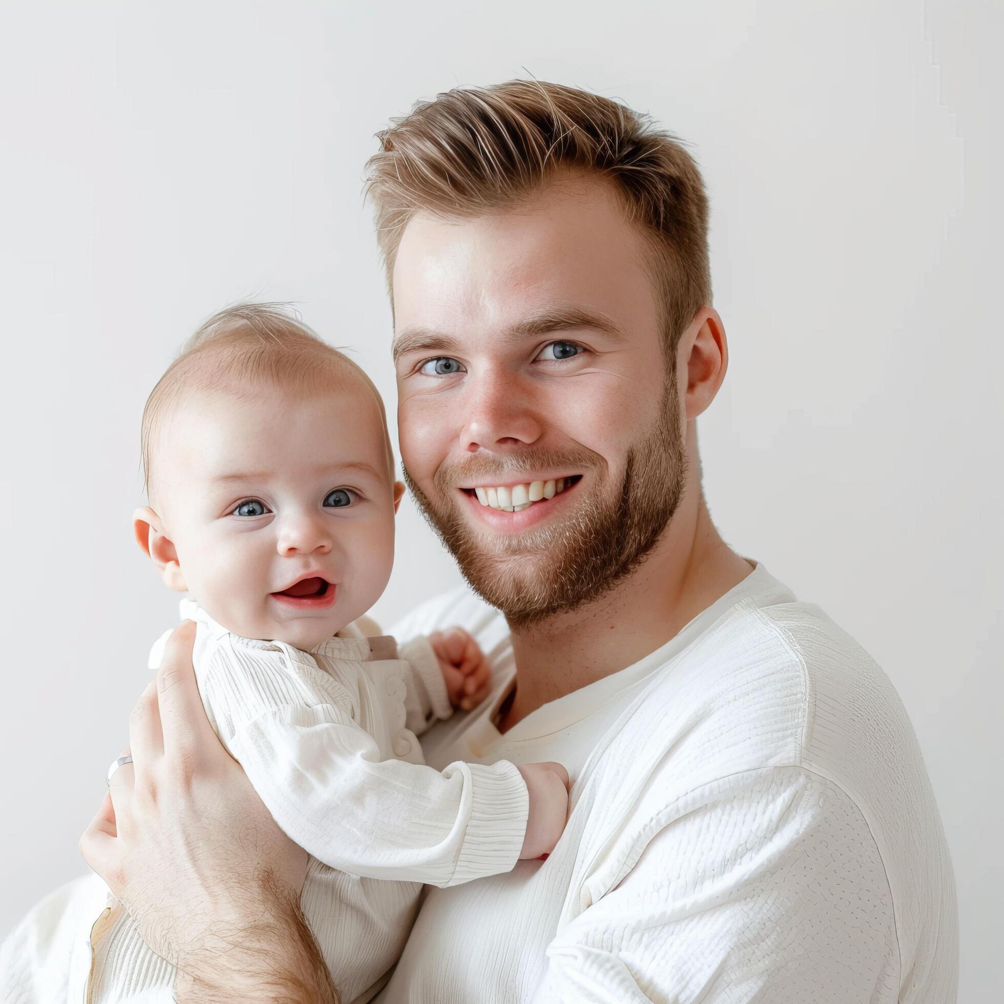 Young father holding a baby in a tender family moment Stock Free