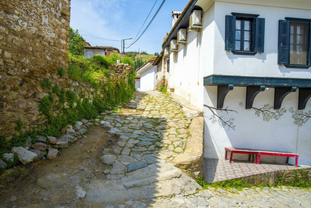 Narrow streets in a Turkish city on a summer and sunny day with old and masonry wooden houses. Stock Free