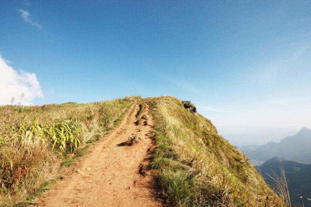 Natural footpath and dry grassland on the mountain with blue sky at Phu Chee Fah hill northern of Thailand Stock Free