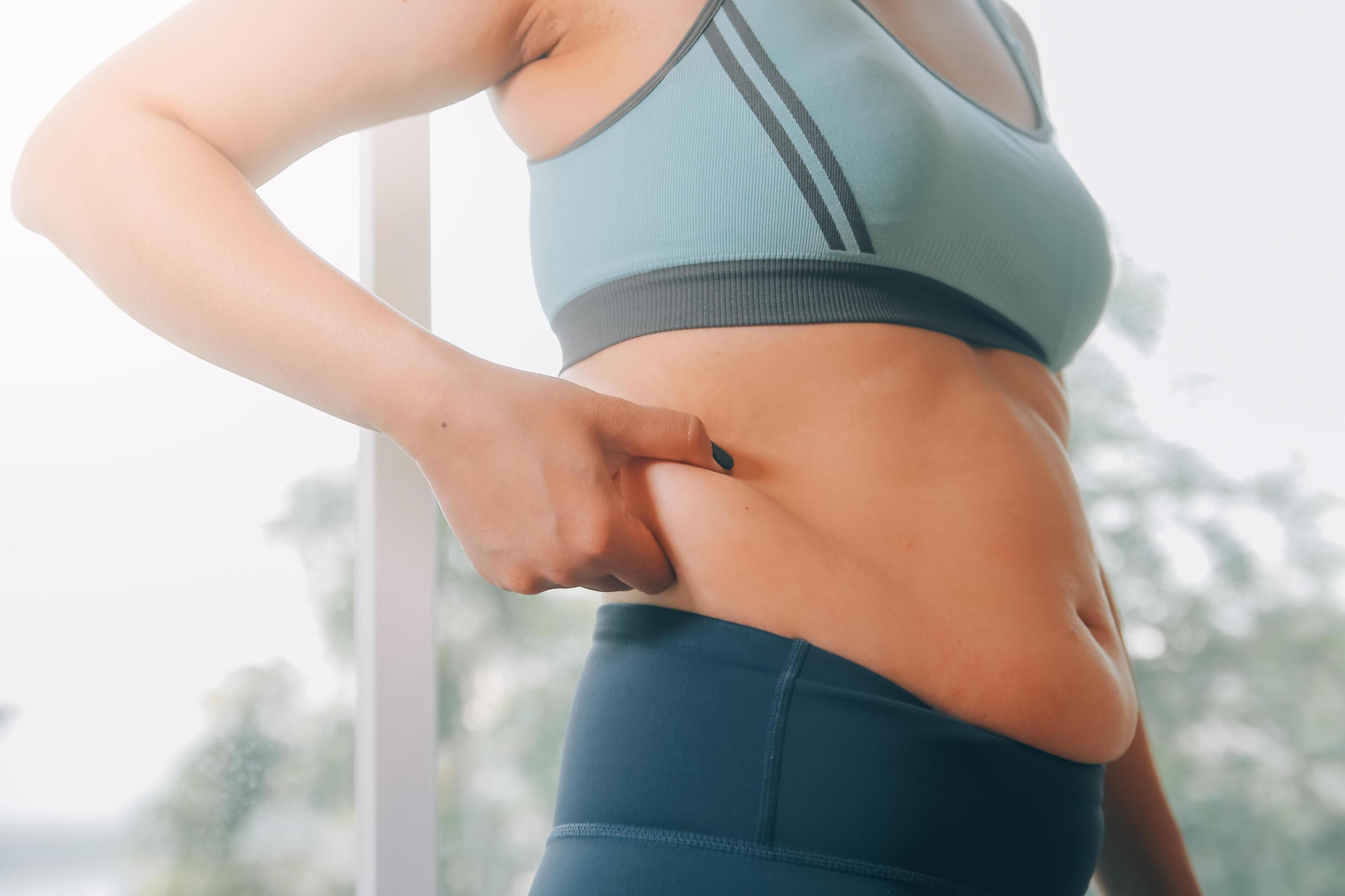 fat woman, fat belly, chubby, obese woman hand holding excessive belly fat with measure tape, woman diet lifestyle concept Stock Free