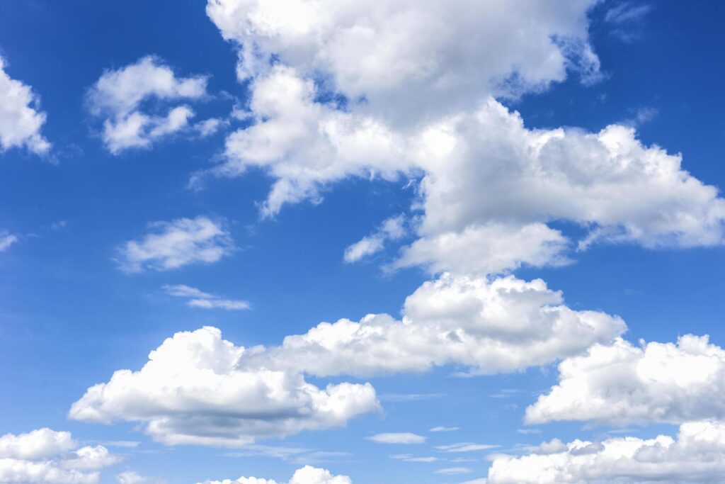 clear blue sky with plain white cloud with space for text background. The vast blue sky and clouds. blue sky background with tiny clouds nature. Stock Free