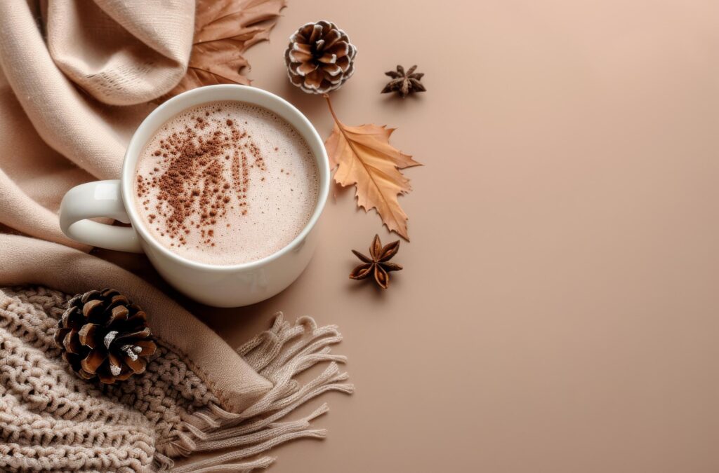 Warm Autumn Drink With Knit Blanket and Fall Leaves on Tan Background Stock Free