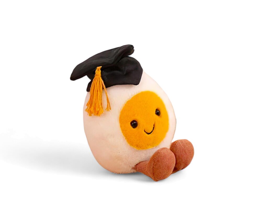 Egg doll wearing a graduation cap on a white background Stock Free