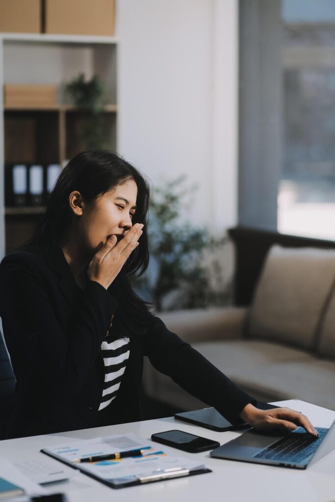 Office asian business woman stretching body for relaxing while working with laptop computer at her desk, office lifestyle, business situation Stock Free