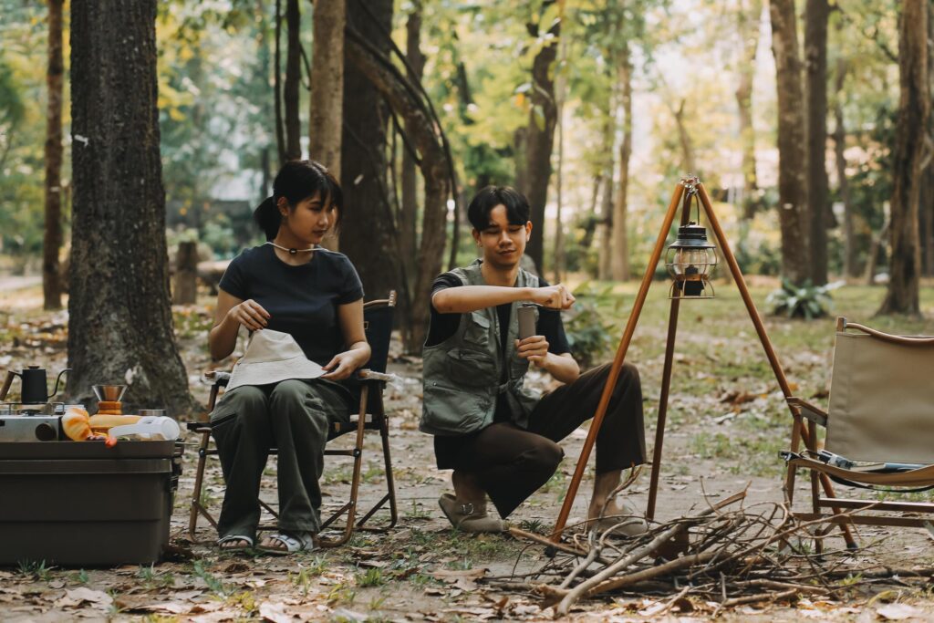 Asian couple sweet in tent inside on they camping trip, traveller relax and sleep togather in out door and camping trip Stock Free