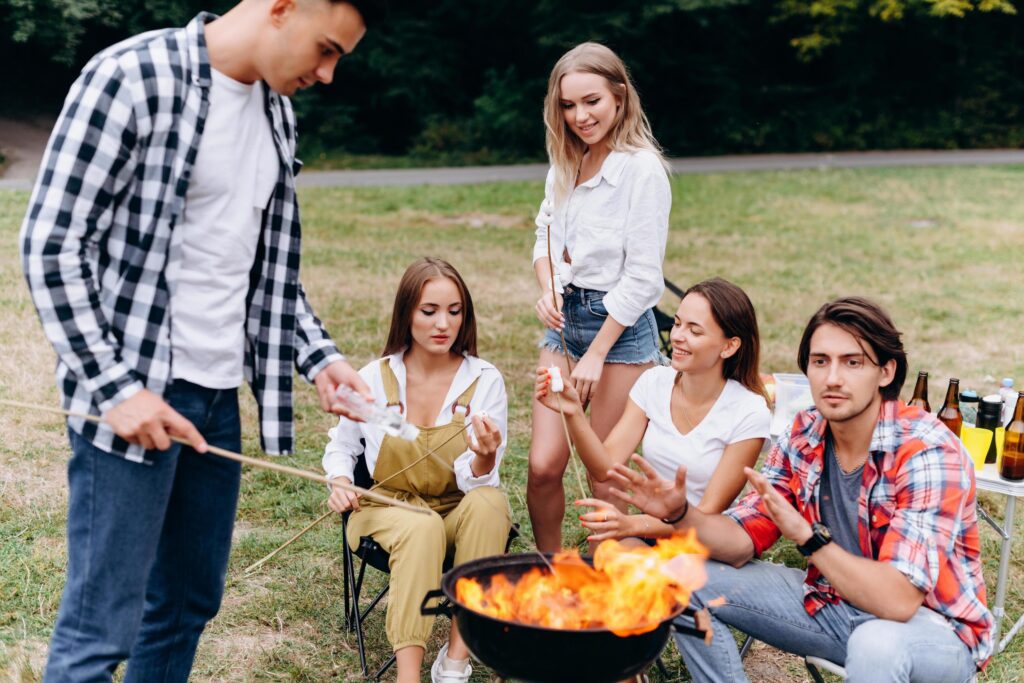 friends in camp cooking grill food Stock Free