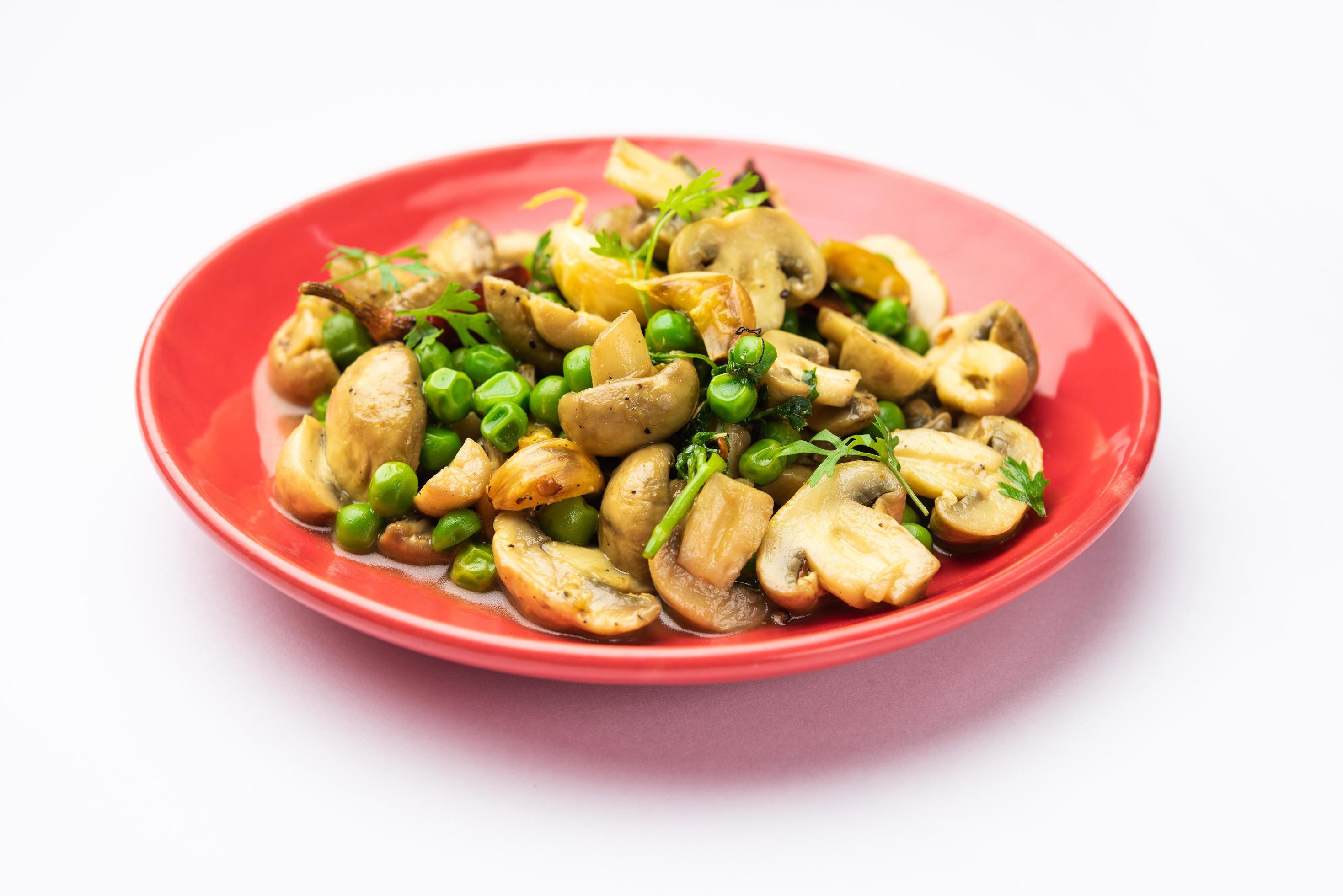 Mushroom and Pea Curry with Roasted Garlic, Indian food served in a bowl Stock Free