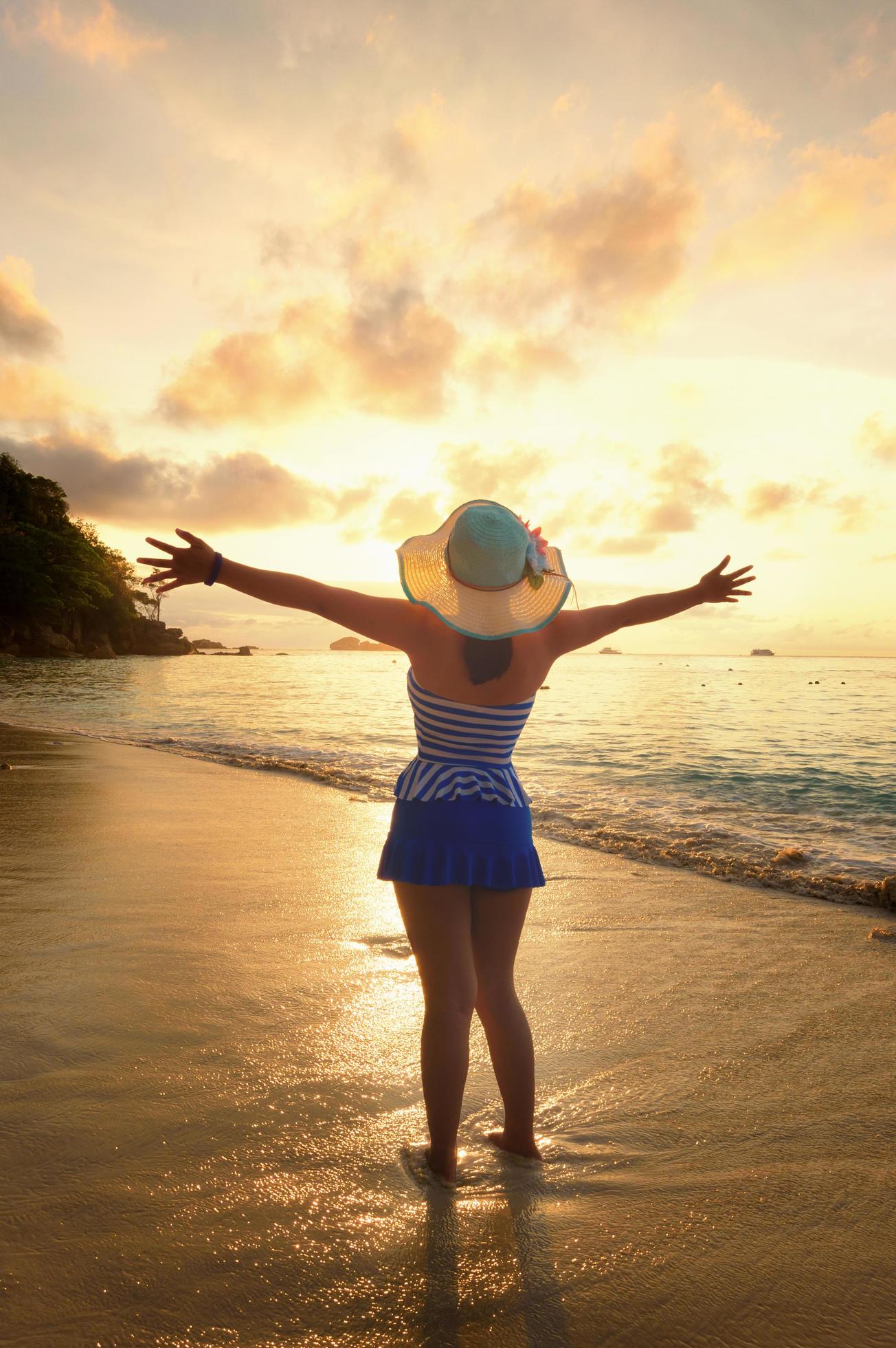 Happy girl on the beach at sunrise Stock Free