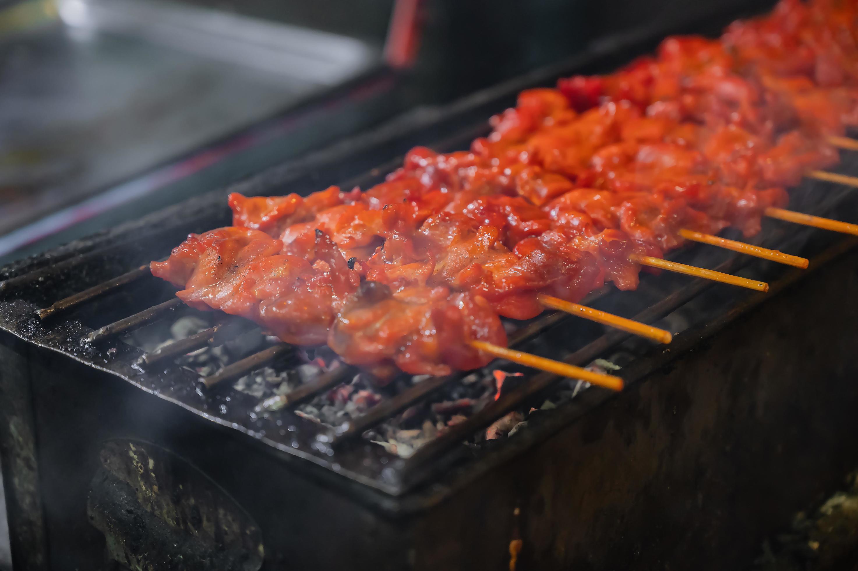 Close up retro Grill chicken stick on the Charcoal stove at street food stall thailand Stock Free