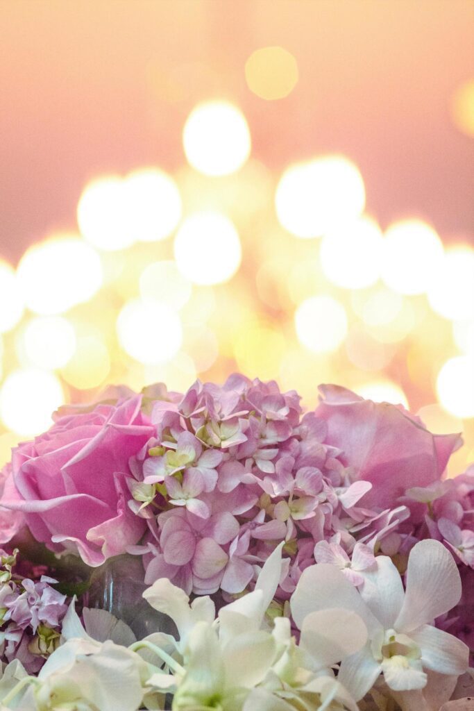 Beautiful blooming flowers on bokeh of candle light background in wedding ceremony. Stock Free