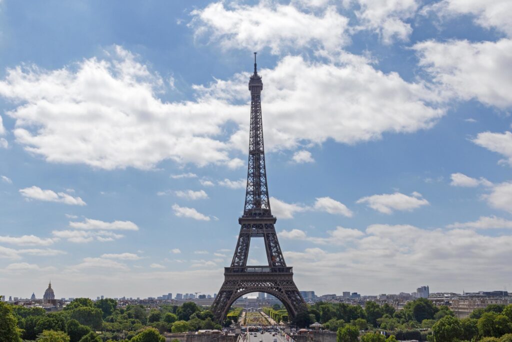 Eiffel tower against blue sky with clouds Stock Free