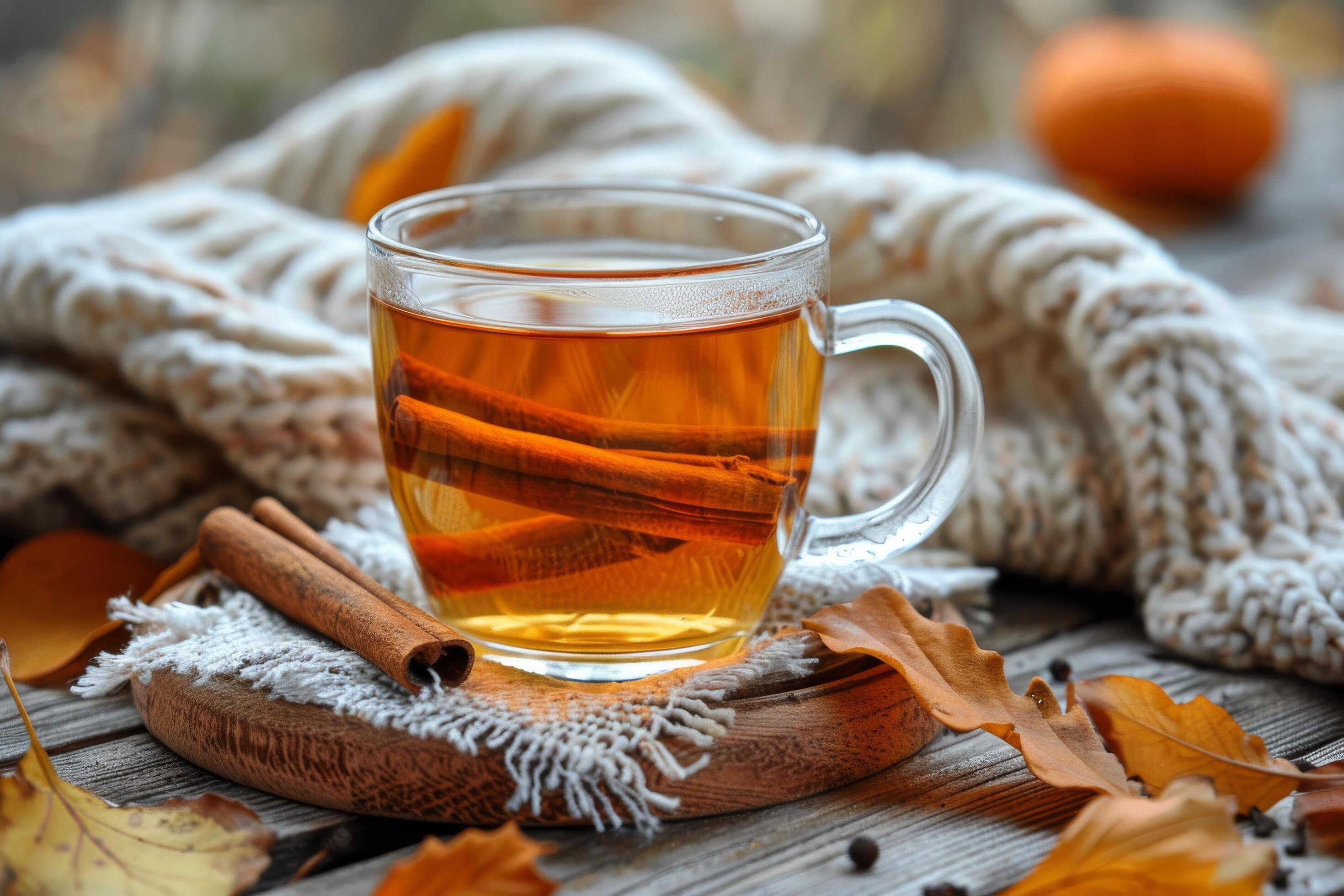 Warm Autumn Tea With Cinnamon Stick and Fall Leaves on Wooden Table Stock Free