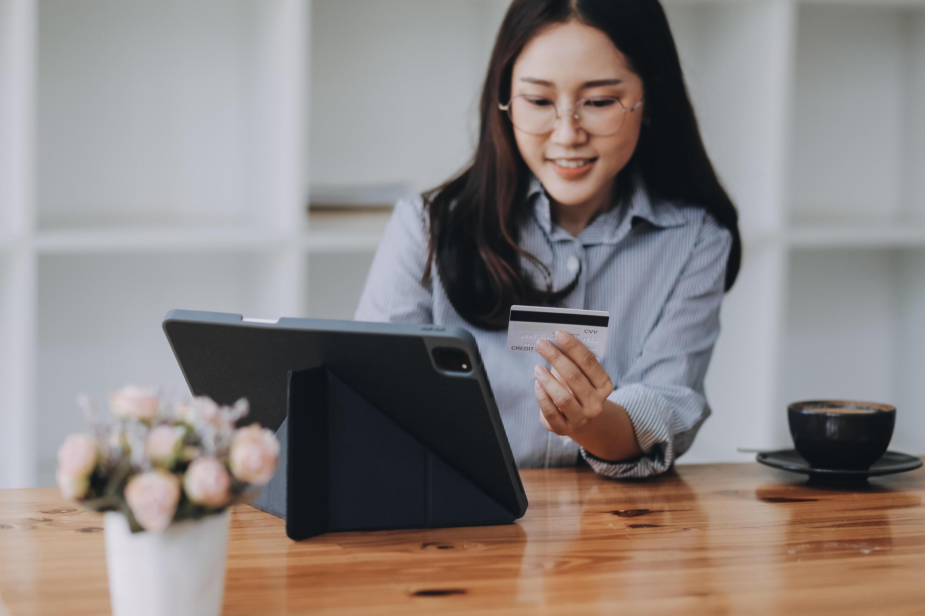 Happy asian woman using smartphone shopping online with credit card. Lifestyle. Easy pay using smart phone or digital device. Stock Free