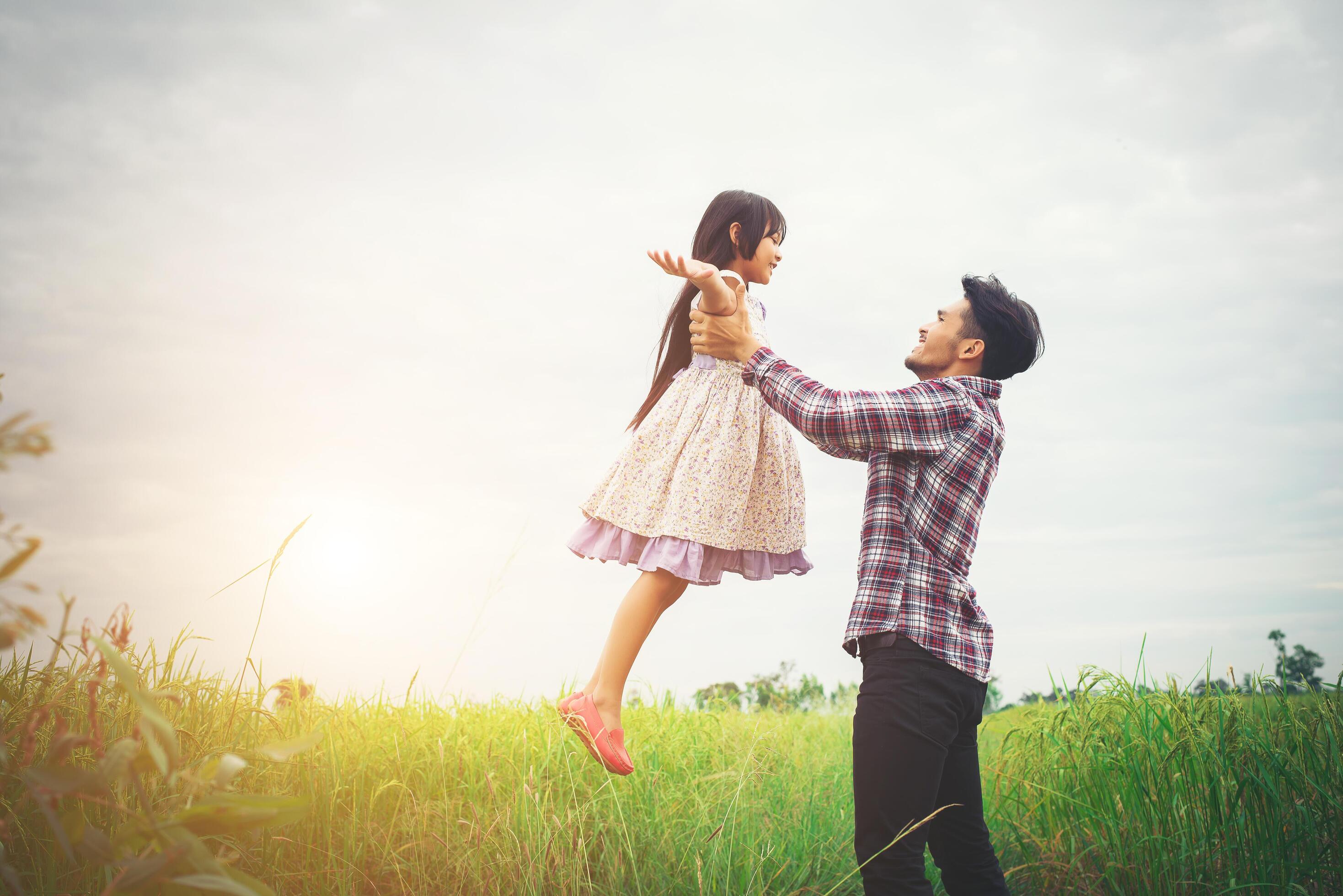 Daddy carrying his daughter with nature and sunlight, enjoyment family. Stock Free