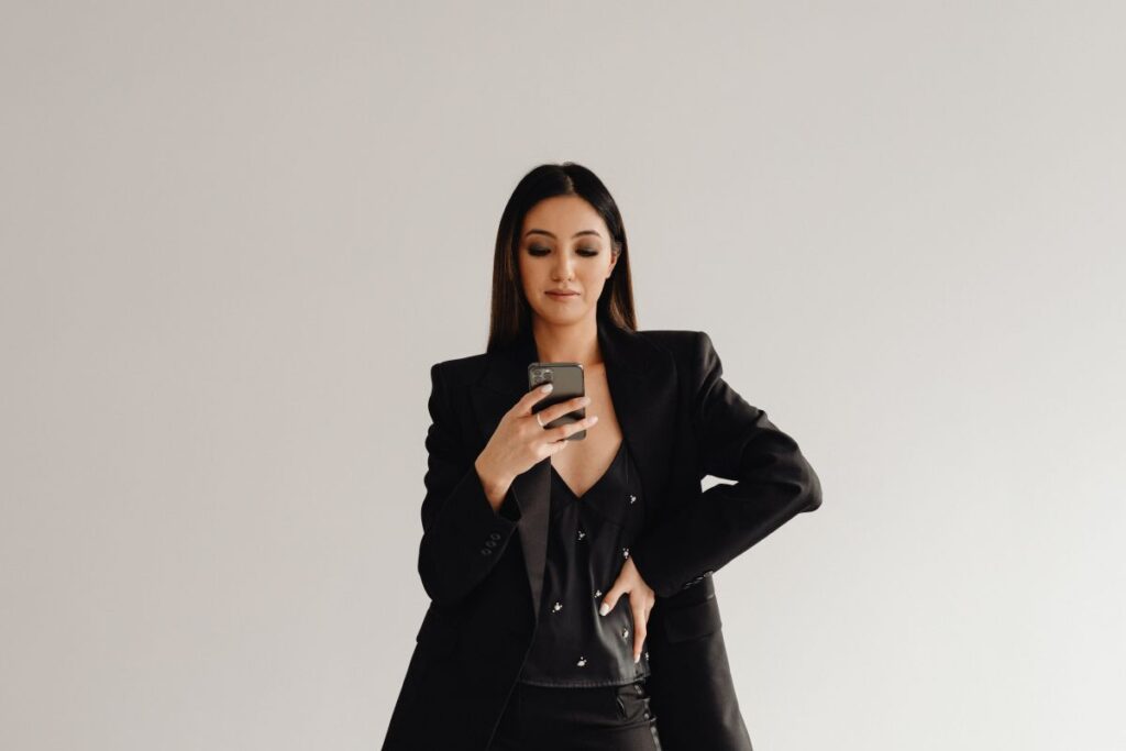 Dark Classy Aesthetic Fashion – Beautiful Asian Female Entrepreneur in Black Suit – Technology and Devices – iPhone – Laptop – AirPods Stock Free