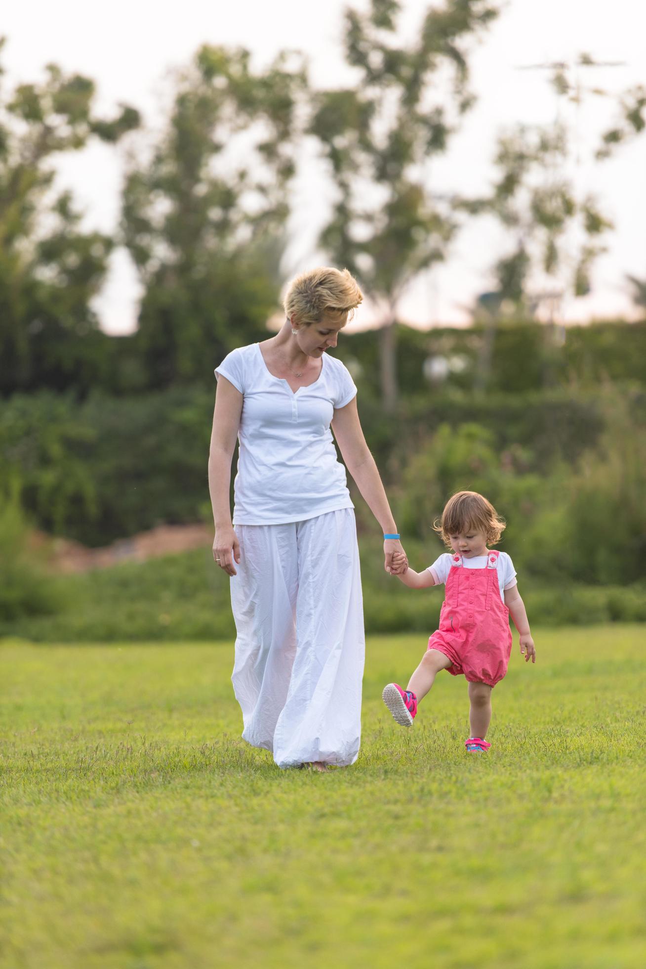 mother and little daughter playing at backyard Stock Free