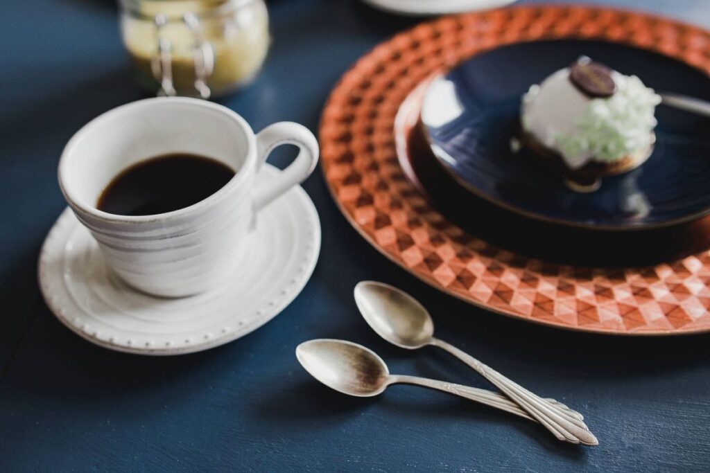 Sweet little white chocolate dessert on a blue saucer in a cake shop Stock Free