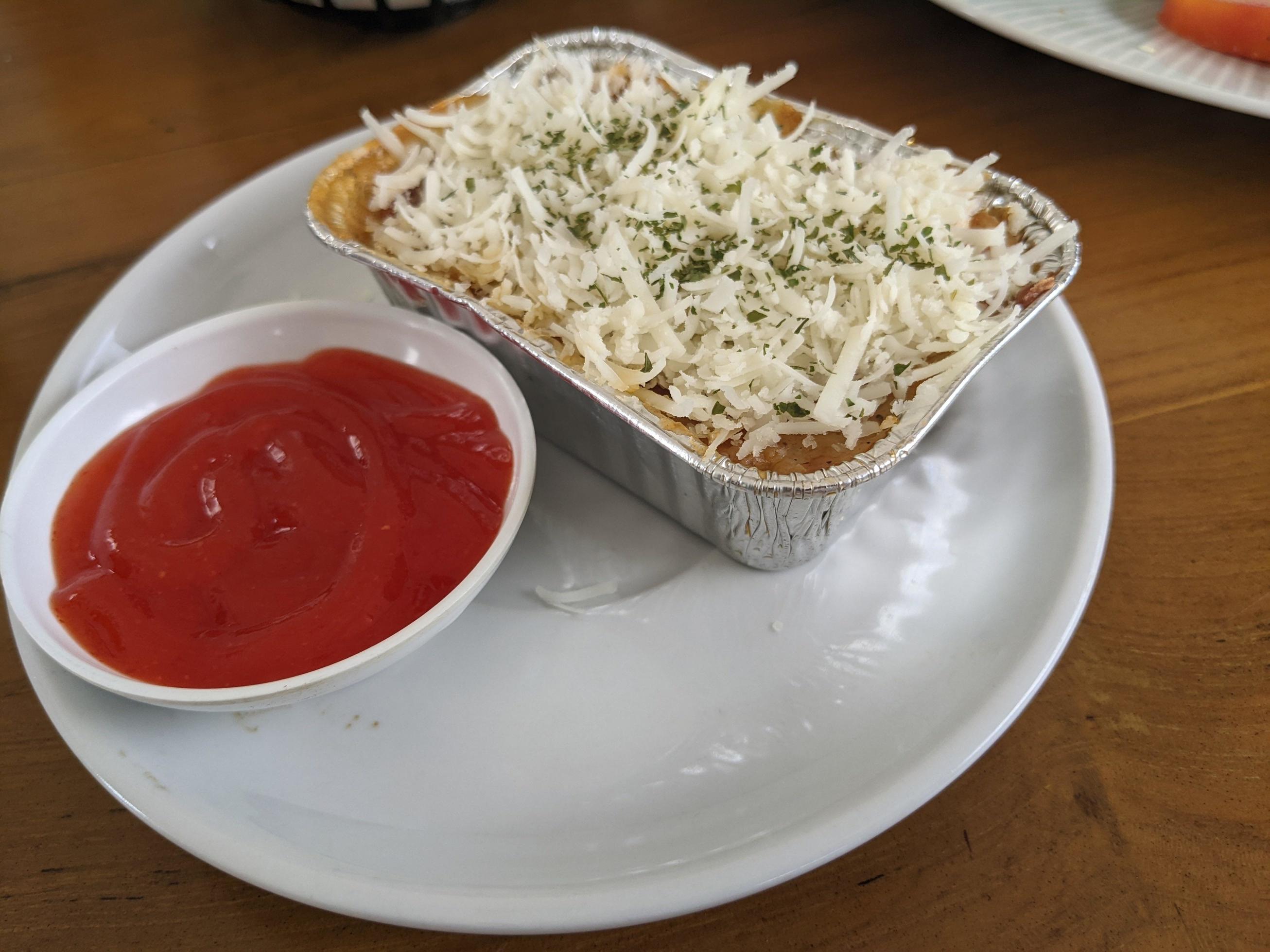 Cedar Cheese and mozzarella on the roasted beef lasagna with chili sauce. The photo is suitable to use for food background, poster and food content media. Stock Free