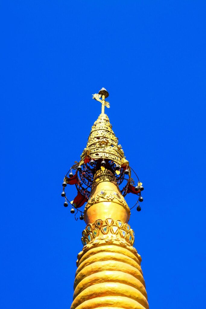 Golden pagoda detail is on architectural style at temple located in Kanchanaburi Province, Thailand. Stock Free