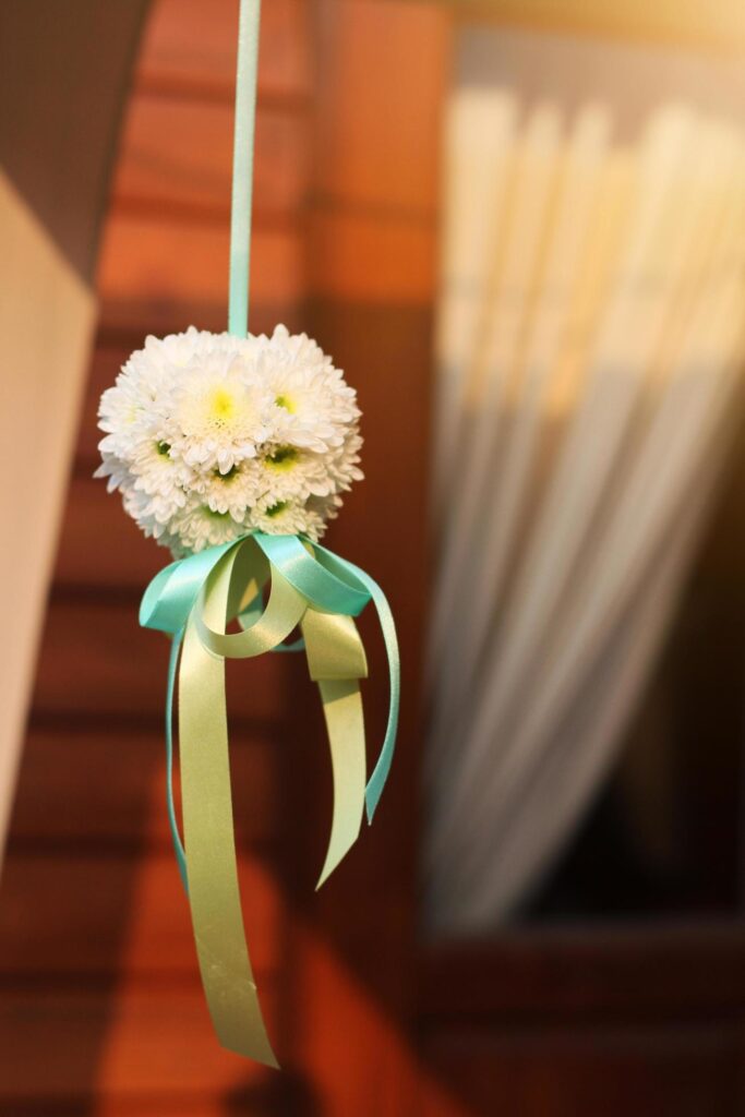 White bouquet flowers with ribbon hanging decoration in wedding ceremony Stock Free