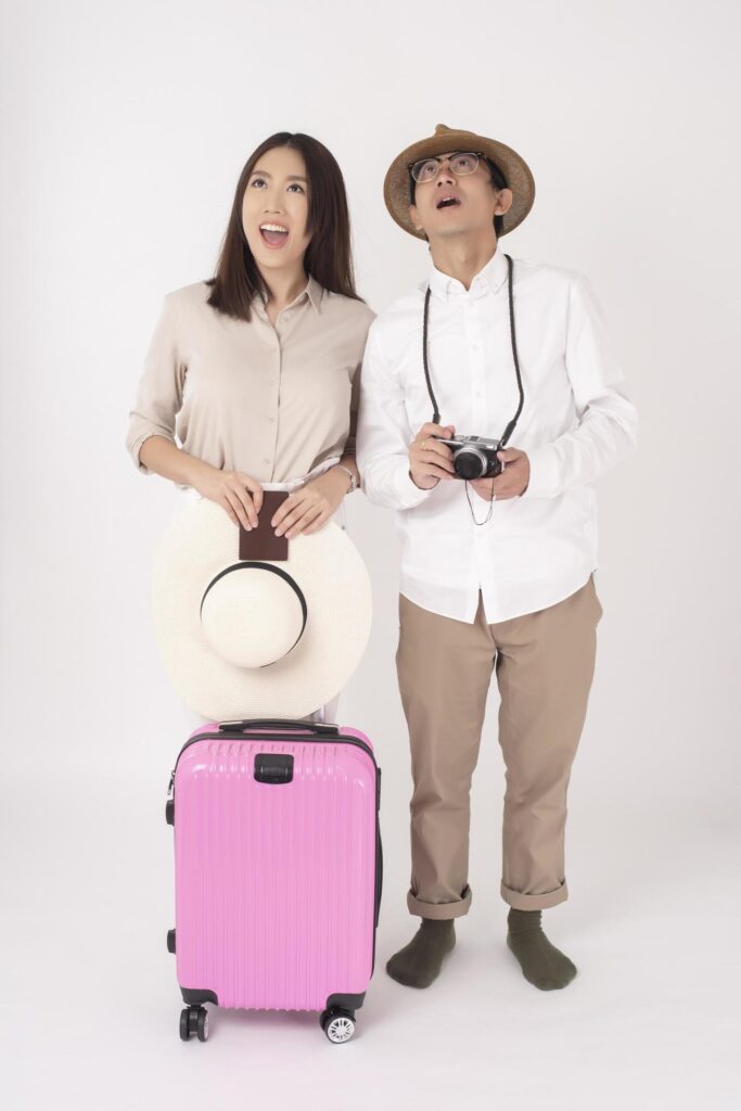 Asian couple tourists are enjoying on white background Stock Free