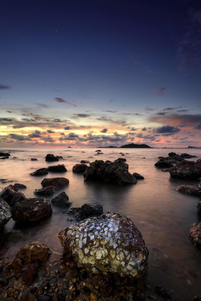 Beautiful seascape. Sea and rock at the sunset. Nature composition. Stock Free